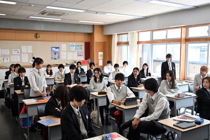 Two girls and a boy studying together